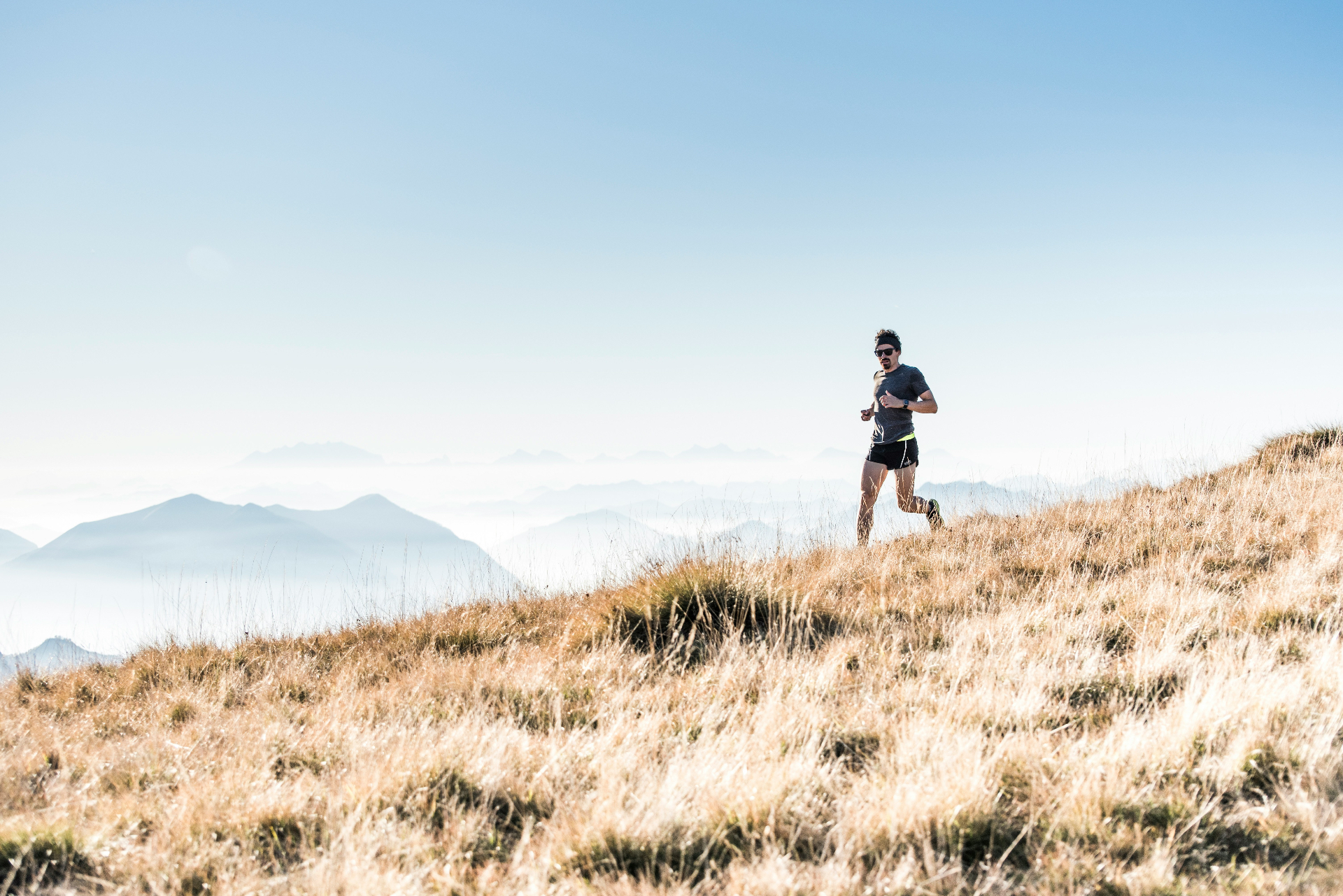 Runner moving through bright alpine trail